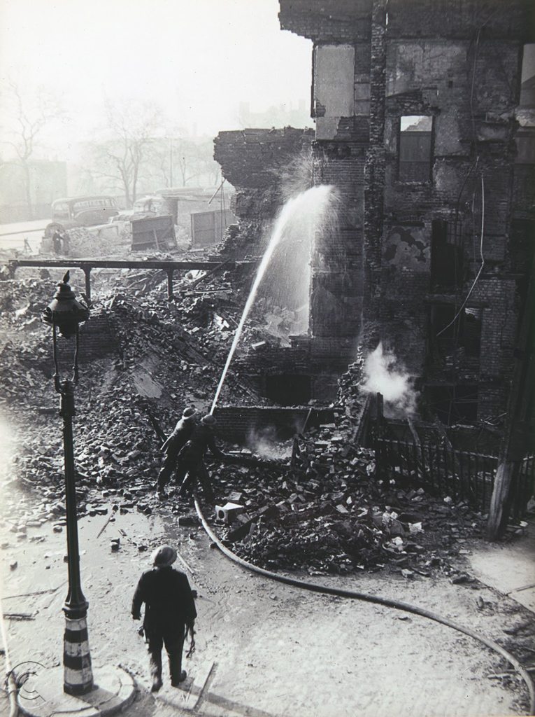 Firemen dousing the ruins of The Circus in 1940 after extensive damage from bombing.